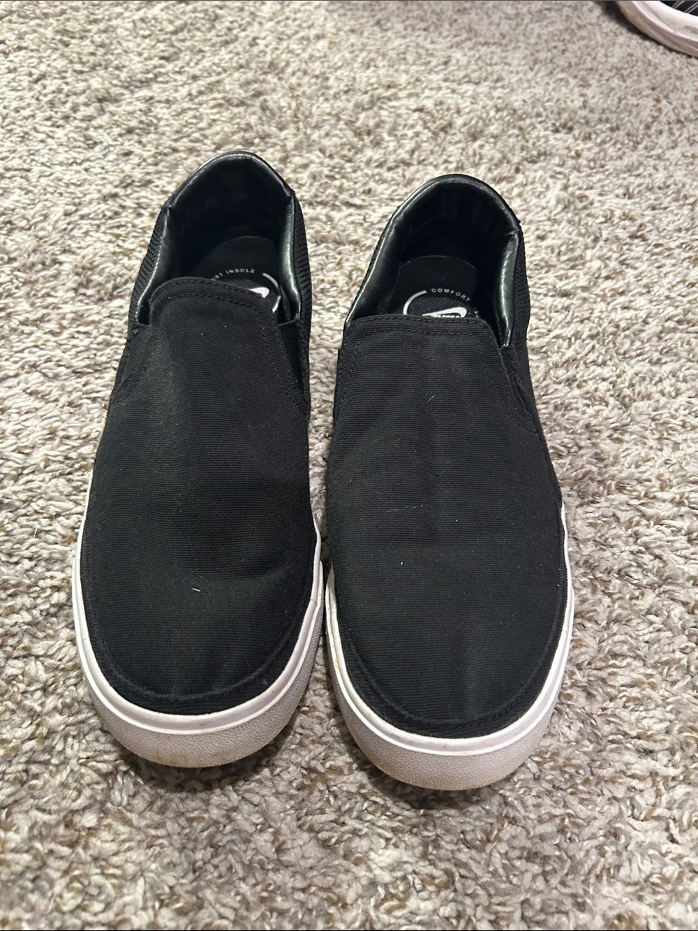Womenโs Nike Black Slip-On Canvas Sneakers